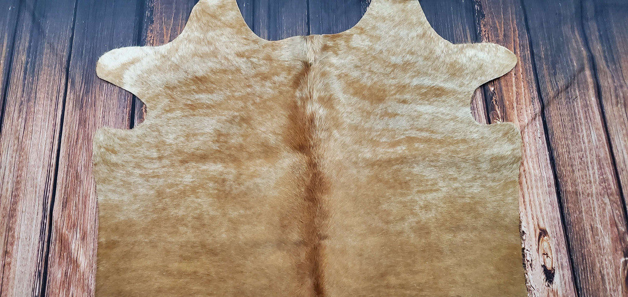 This small cowhide area rug is beautiful in real life and the color palette is vibrant. It is a lovely accessory for any living room.
