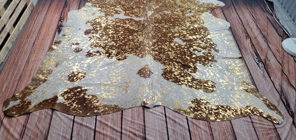 Metallic cowhide area rugs are lovely for any room, with gold metallic on brown and white
