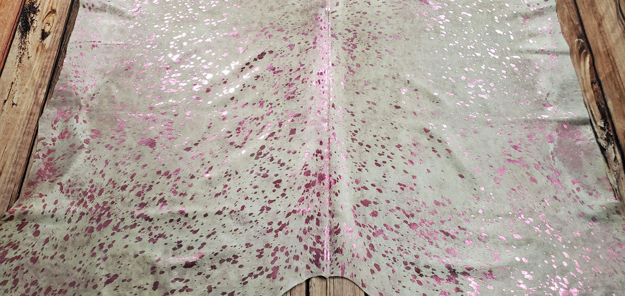The hair on cow hide rugs are perfect to use metallic cowhide fabric. These are pink metallic washed on white cowhide. 
