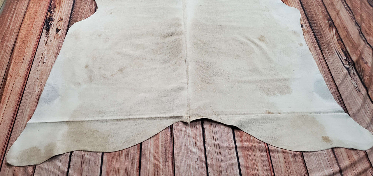 A cowhide rug is a unique and stylish addition to any home. The natural ivory and beige colors of the cow hide add a touch of elegance to any room. 