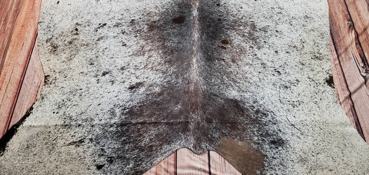 A Truly real and natural premium Brazilian cowhide rug, mix of natural blackish, brown and white. 
