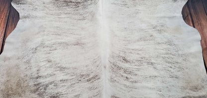 Incorporating this brindle cowhide rug with sheep skin makes a truly gorgeous combo. The grey shade in the rug's color is very beautiful and bright, the genuine, pure look is terrific for any room.
