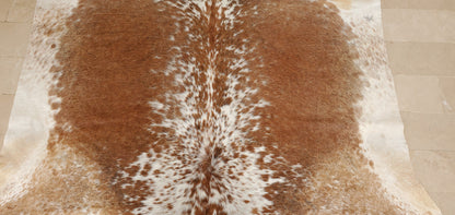 Bring your office to life with this stunning and unique geniune speckled cowhide rug! This rugged addition is sure to create a warm, inviting atmosphere in any workspace. 
