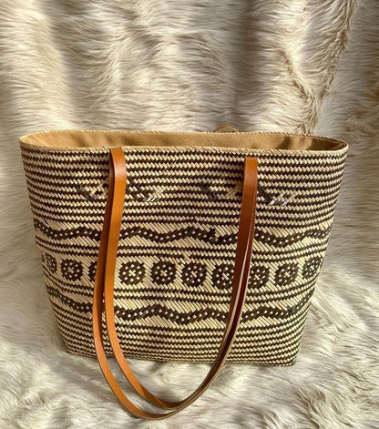 Use a rattan bag as a stylish alternative to a traditional shopping bag, as it is environmentally friendly and can hold all your purchases.