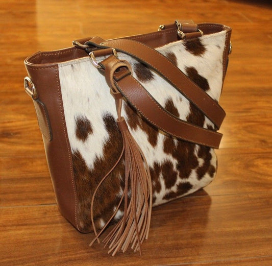 A unique cowhide tote bag in speckled brown white with premium leather handle.
