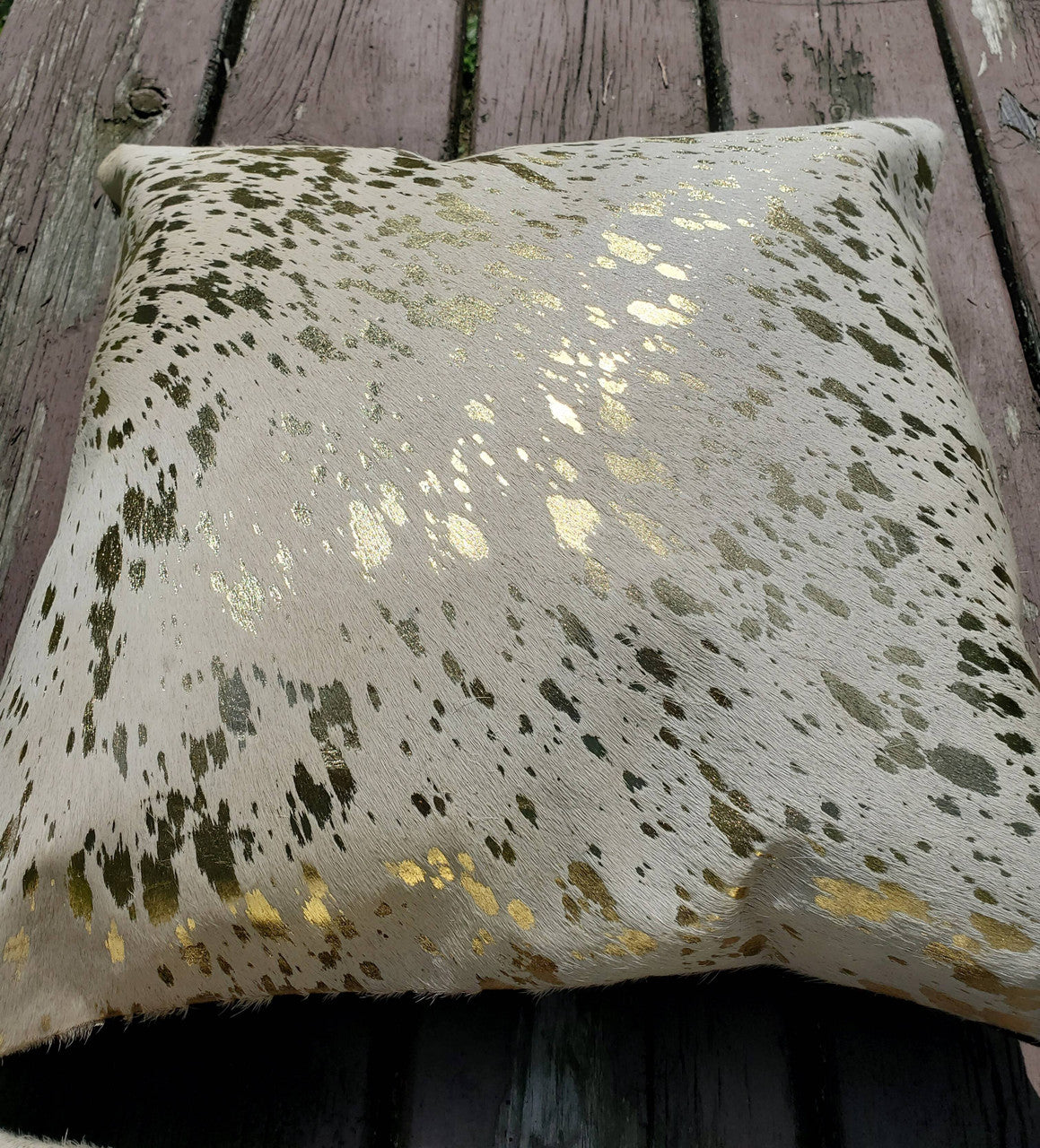 Beautiful cowhide pillows. High quality gold metallic brings the invite and intrigue to any space.


