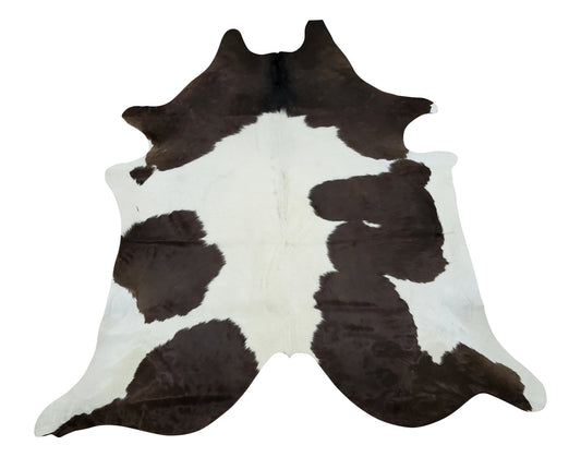 Handpicked small cowhide rug with lots of white, reddish-brown and some black in the background, this piece will give luxurious touch. 