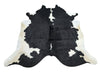 Add a luxurious touch to any room with this stunning large Holstein cowhide rug! Its quality is amazing and its solid black and white shine will surely brighten up any space.