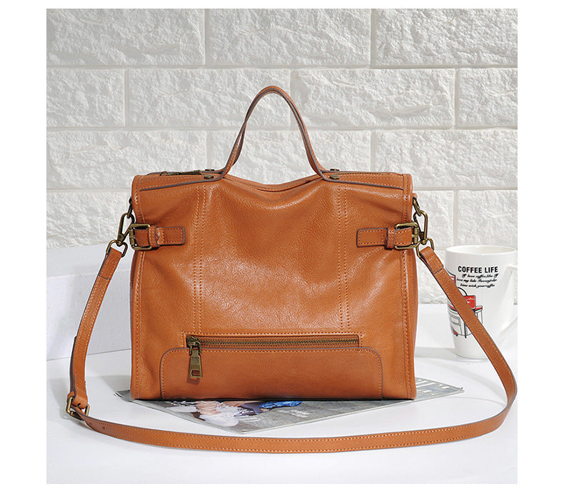 Womens leather commuter bag with crossbody carry option and secure zip top design