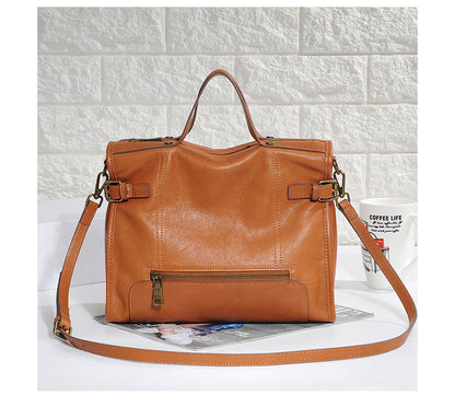 Womens leather commuter bag with crossbody carry option and secure zip top design