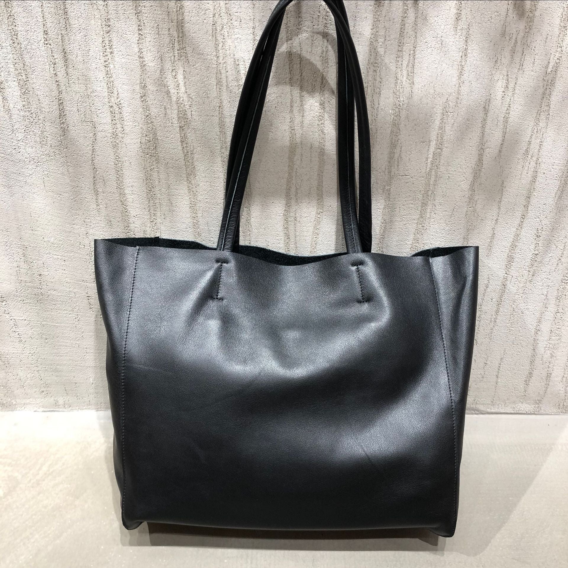 Genuine leather tote bag for women with large capacity, shoulder carry design, and clean structured shape