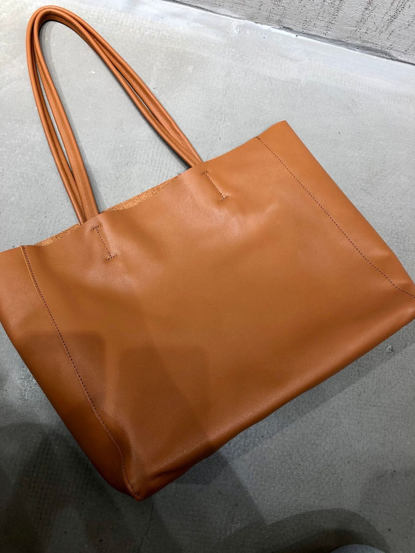 Top grain cowhide leather tote purse with structured base and open interior for everyday use