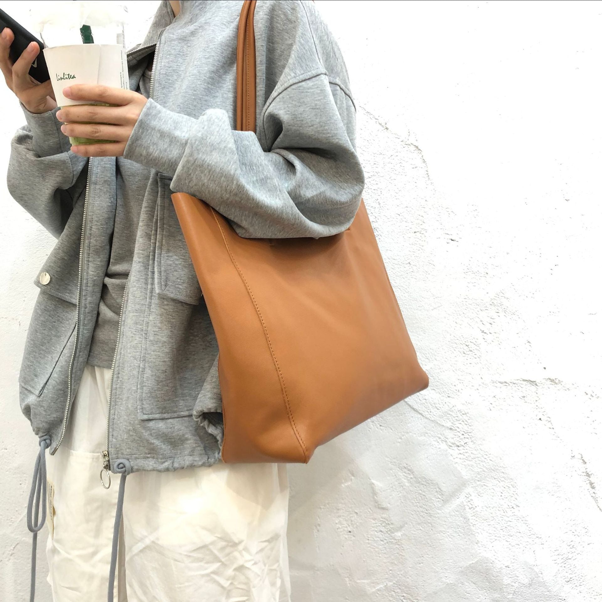 Large leather tote designed for underarm and shoulder use, ideal for work and daily essentials