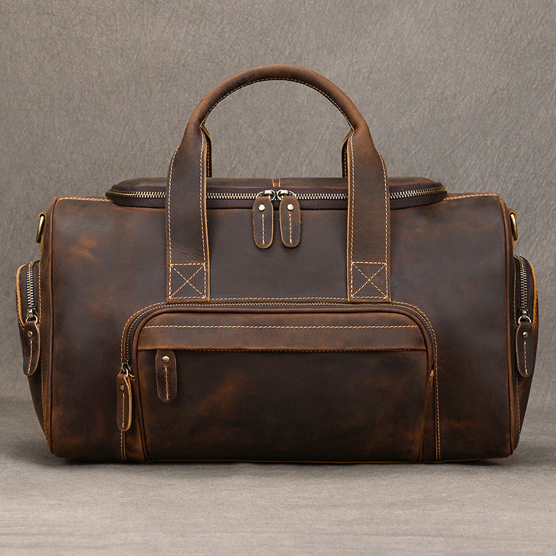 Retro leather duffel bag for men with cowhide body, shoulder strap, and multi-pocket travel layout