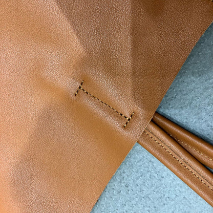 Large shoulder leather tote for women with reinforced handles and clean stitched construction