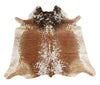 A speckled cowhide rug in a unique faded brown and white in edges it will great statement piece for dining room and fit any decor. 
