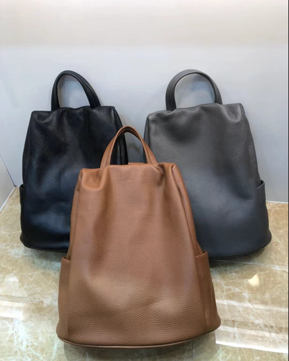 Grey genuine leather backpack tote with dual carry straps, spacious interior, zip closure for daily work and travel