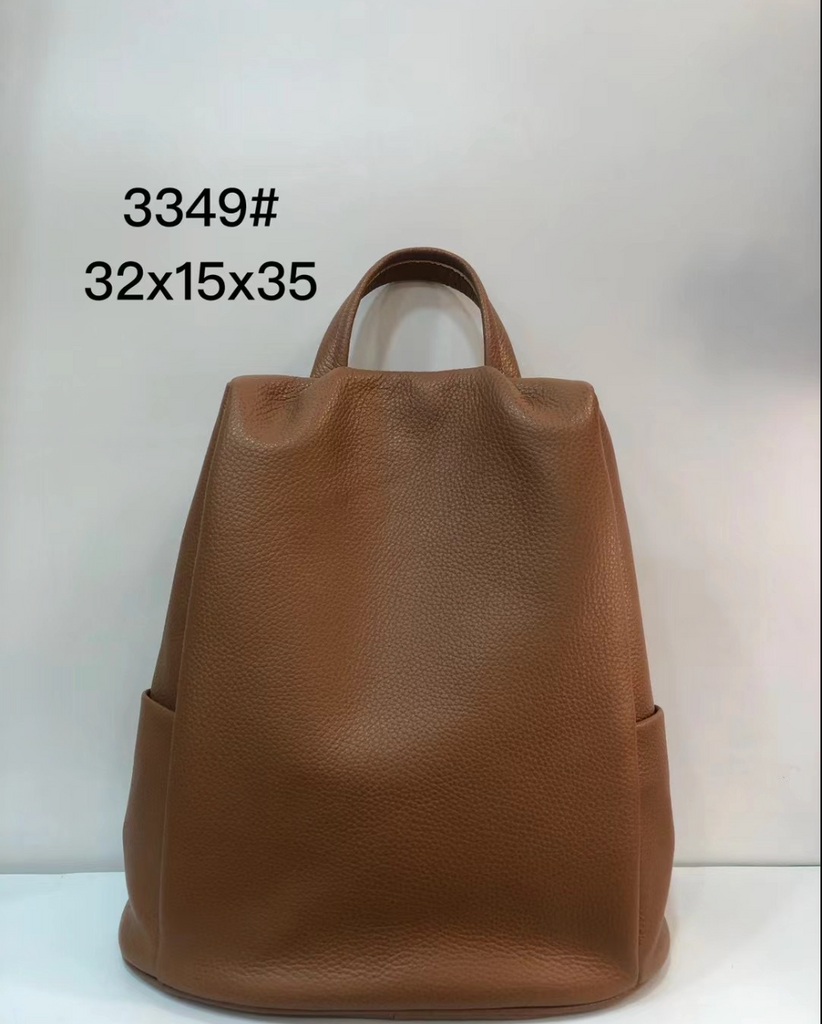 Leather tote purse with backpack function, grey cowhide finish, structured body, and easy access zip opening