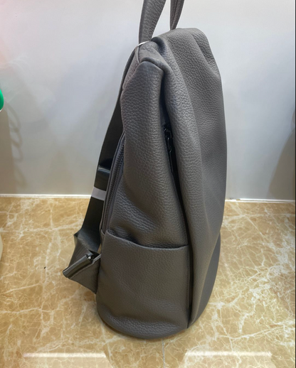 Large leather tote backpack combining top handles and shoulder straps for flexible daily and travel use