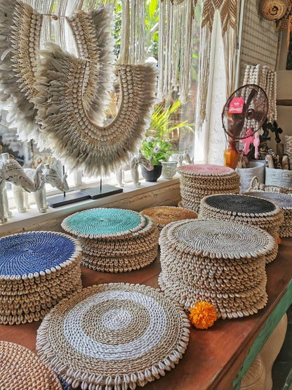 These rattan placmats with shells are great to use as trivets, trays or chargers. Very well made from natural rattan at the end is cowrie shells.