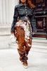 Cow print pants made from brown and white cowhide leather. Real cow skin trousers with high waist and wide leg for standout western outfits.

