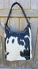 This stylish and unique black and white cowhide bucket bag is perfect for any one who wants a stylish and sophisticated bag that is also unique, this bag is made from high quality cowhide.