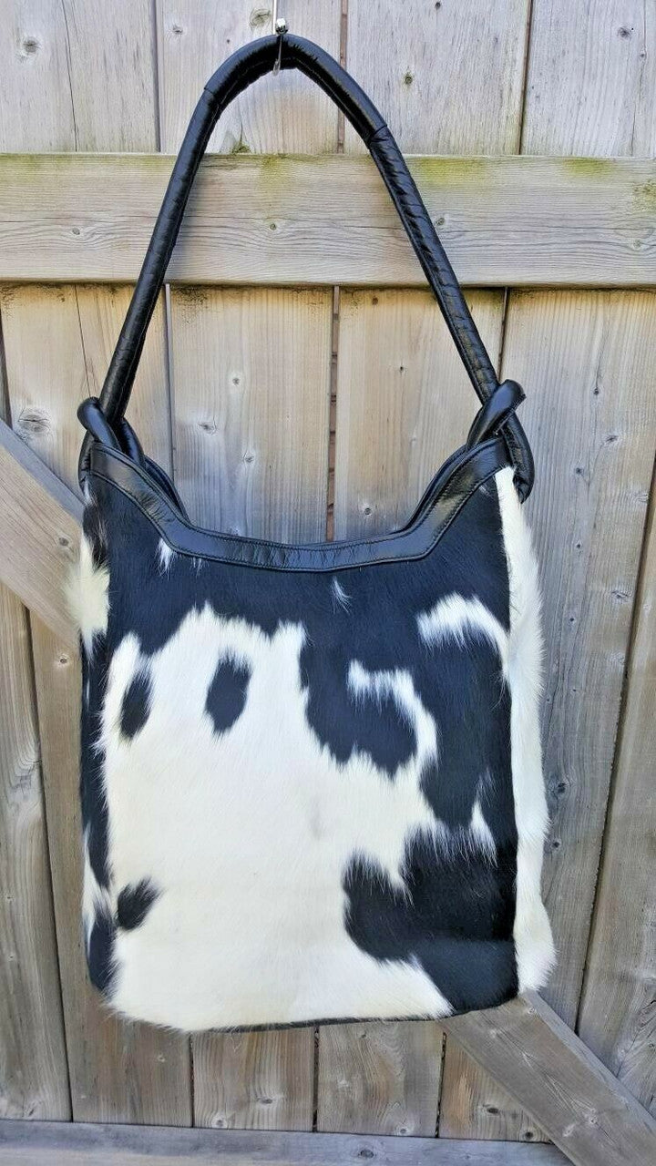 This stylish and unique black and white cowhide bucket bag is perfect for any one who wants a stylish and sophisticated bag that is also unique, this bag is made from high quality cowhide.