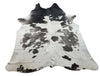 This cowhide rug is not only for aesthetic looks but  help with the echoey acoustics of that part of the apartment plus its natural, genuine and free shipping.  
