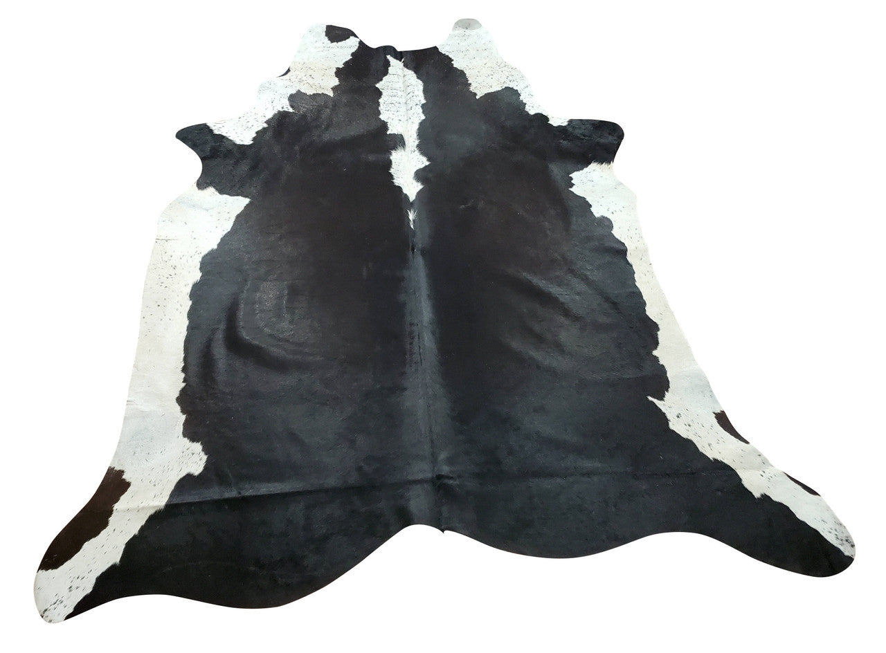 If you have spend months looking for a cowhide rug this black and white will be great start to a positive mamoties, hang it on the wall or use it for entryway. 
