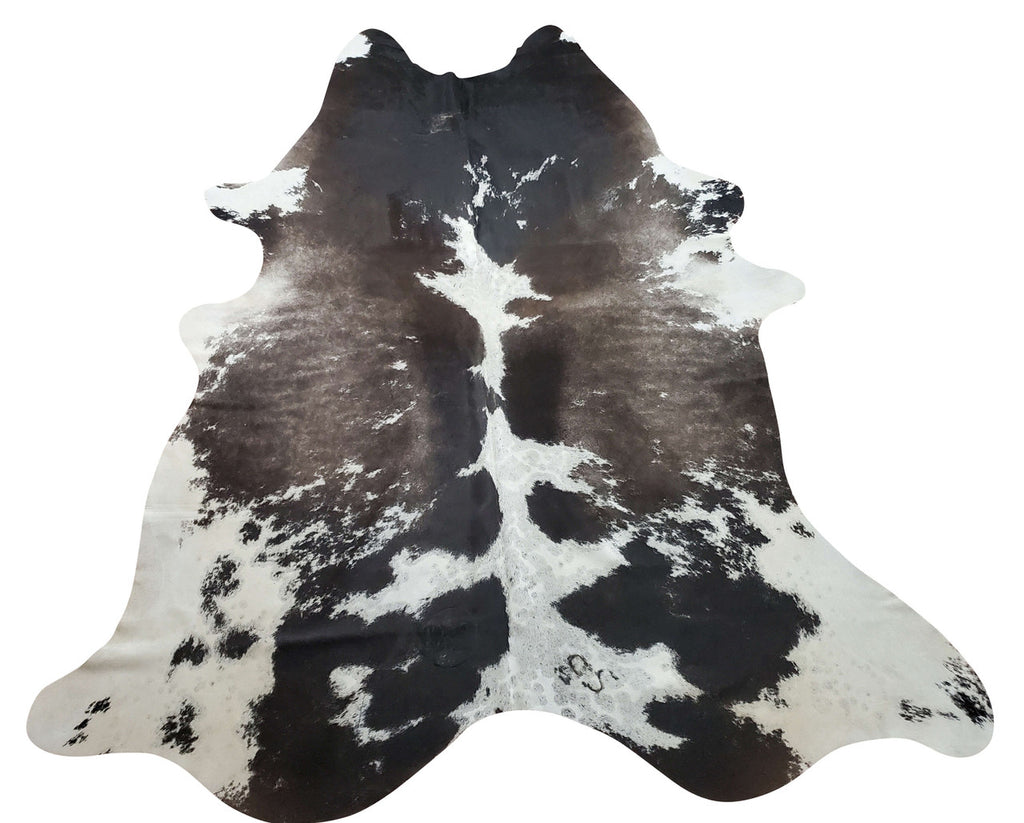 There is nothing nicer than a dark cowhide rug in a stunning gray white, looks so inviting you might even choose to sit on it. 
