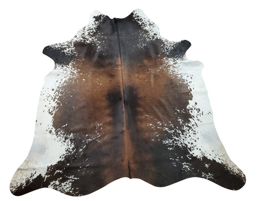 You will be pleased with the large chocolate cowhide rug a great balance of white to many shades of brown and a few black spots no odd smell or markings .
