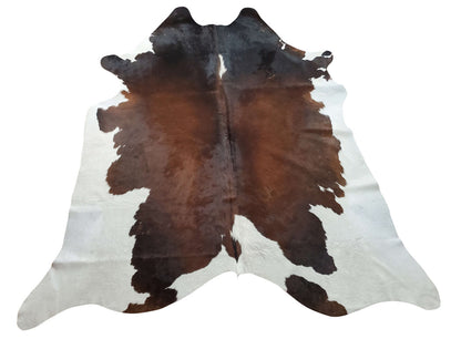 Make a statement with this stunning real cowhide rug. A unique tricolor combination of dark brown, blended black and white on the edges. 
