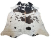 This tricolored cowhide rug is comprised mostly of dark gray, black and white speckled. It's well-made and very beautiful.
