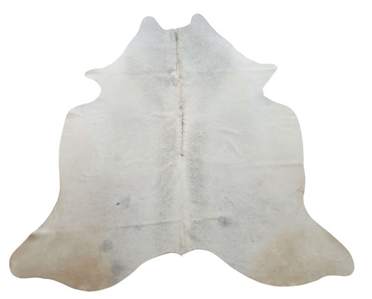 This natural cowhide rug is mostly cream white with slight grey in the background, very soft and high quality, amazing for high traffic areas, entry way or even rustic kitchen or dining room. 
