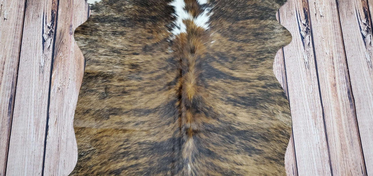 This small cowhide rug is perfect for adding charm and beauty to any interior. It is made from genuine cowhide, so it is durable and long lasting.

