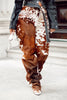 Custom women cowhide pants with brown white cow print. Real hair on hide trousers designed from authentic cow skin for standout fashion styling.