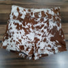 Cow print shorts made from genuine brown white cowhide leather. Women's western shorts with natural fur finish and handcrafted edge.
