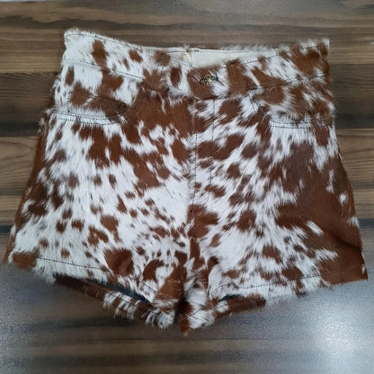 Cow print shorts made from genuine brown white cowhide leather. Women's western shorts with natural fur finish and handcrafted edge.
