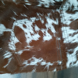 Genuine cowhide shorts for women featuring cow print leather in brown and white. Real cow fur finish adds bold western-style flair.

