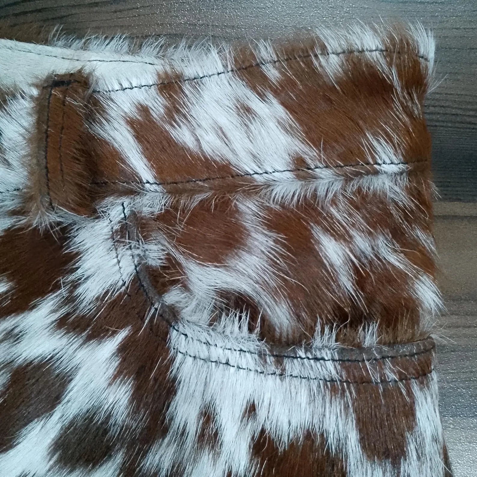 Stand out in real cow fur shorts for women. These brown white cowhide shorts feature hair-on-hide leather and authentic western appeal.

