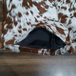 Brown and white cowhide shorts for women with cow fur texture. Real cow print leather brings bold western attitude to your wardrobe.

