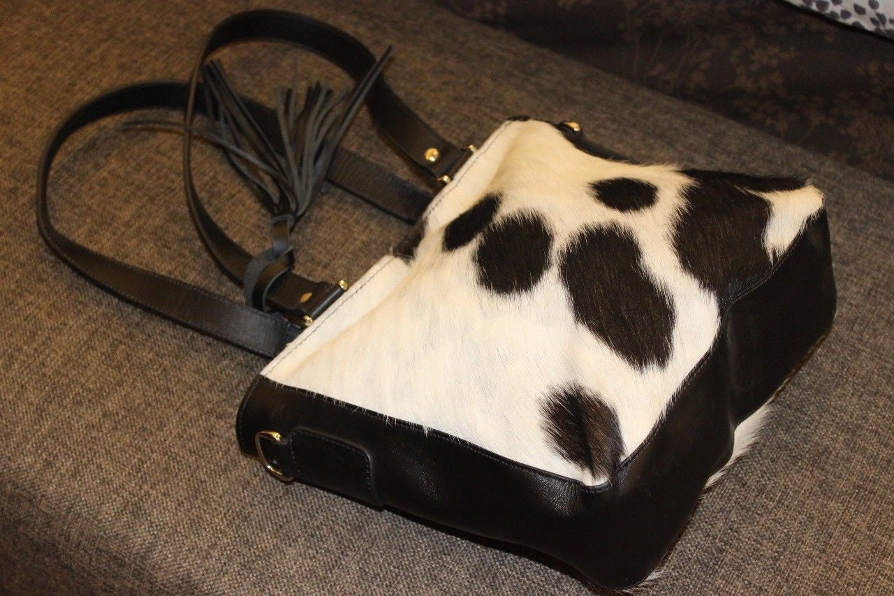 A very nice cowhide fur bag, very sturdy and good quality, comfortable to wear thrown over your shoulder, custom made in black, brown white hair on hide