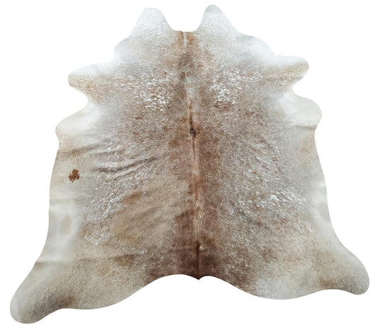 Beige cowhide rug is an encyclopedia of colors, the darker edges will easily keep up with the latest trends of a living room.  
