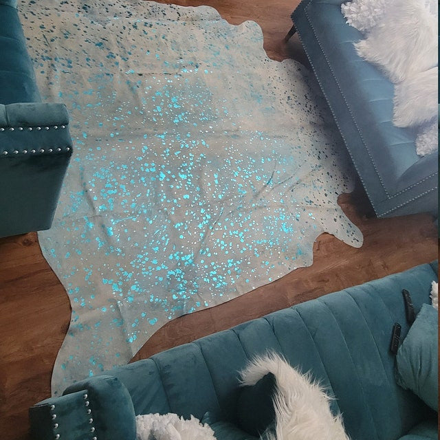 Bring a modern, metallic touch to your home's decor with this stunning silver cowhide rug. Its unique texture and shimmering hue will be sure to make a statement!