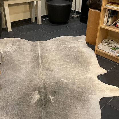 Transform your home with a beautiful, natural large cowhide rug. Perfect for modern decor, add a touch of luxury to any room with this durable and stylish piece.