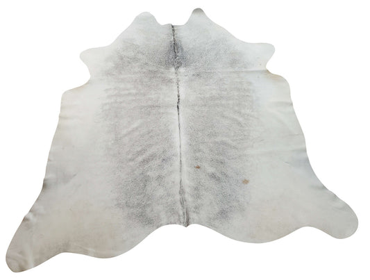 One of the best way to design large cowhide rug is layering a couple of them, it totally looks out of a home decor magazine, these gray are true charm

