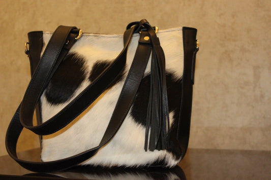 You will love this cowhide bag, we can also make makeup case in black and white to match you custom messenger bag, this is perfect for any day and event