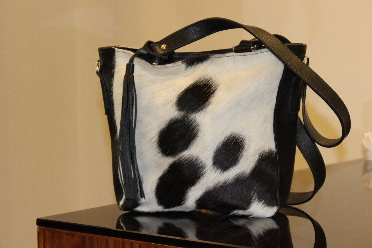 A nice cowhide bag with thick leather handle, made from soft and real hair on cow skin, great to carry around and carries a lot of stuff and good smell