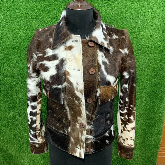 Genuine cowhide jacket for women with real hair on cow skin and bold tricolor cow print. Natural hide pattern with western-inspired design.

